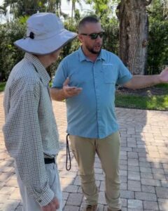 ISA Certified Arborist from Joshua Tree Inc. consulting with a homeowner during a tree health assessment